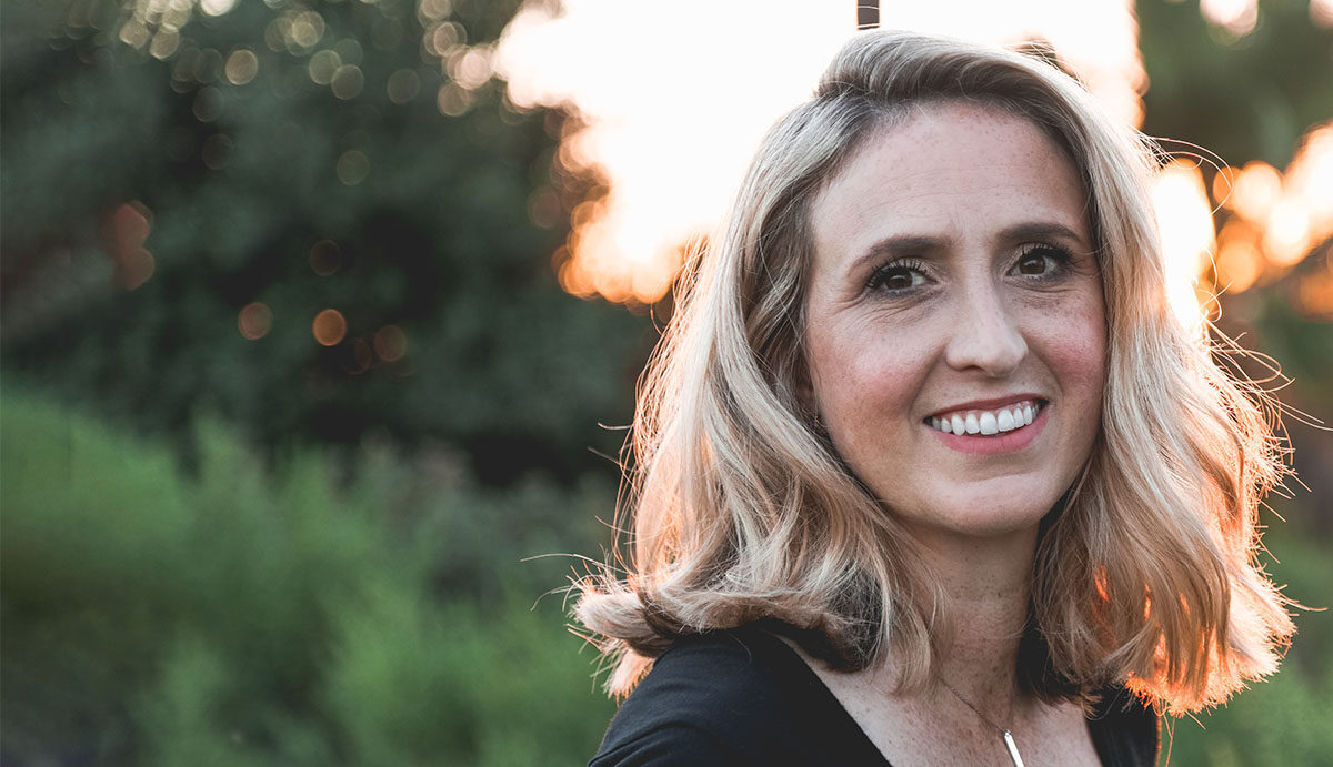 middle aged woman smiling in field