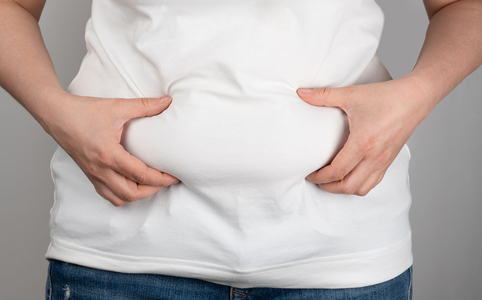 Woman holding flabby belly