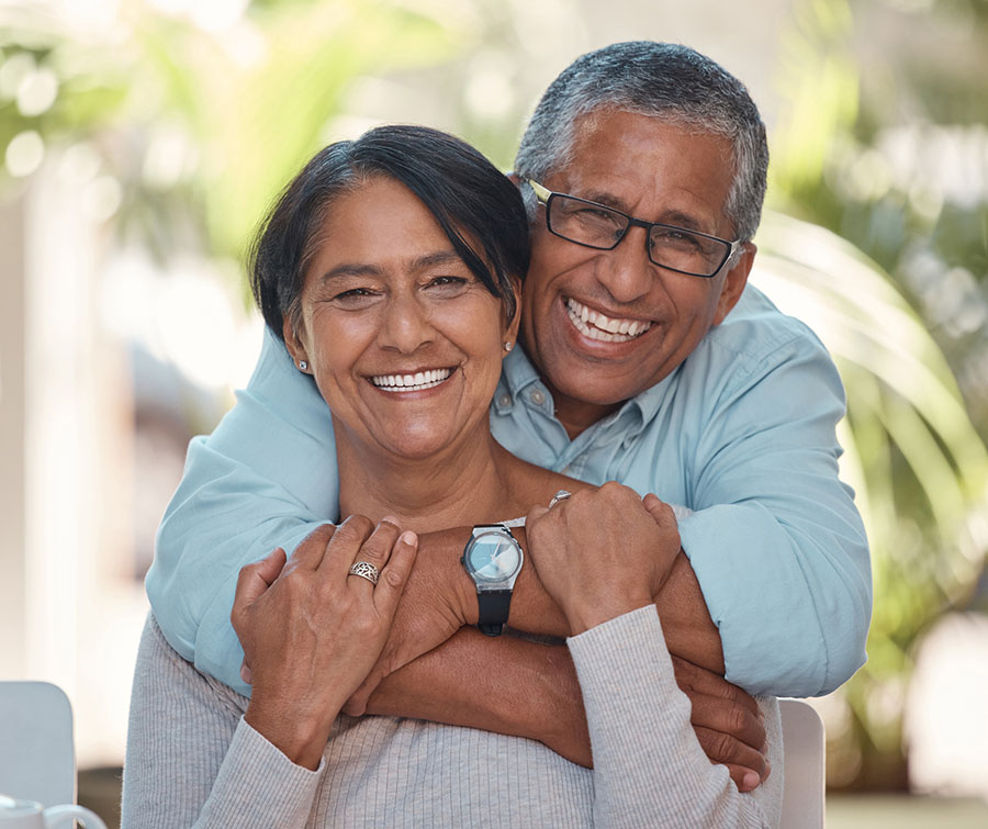 Portrait, elderly and couple bonding on a patio at home, hug, laugh and relax outdoors together. Love, retirement and happy seniors enjoying their relationship and bond